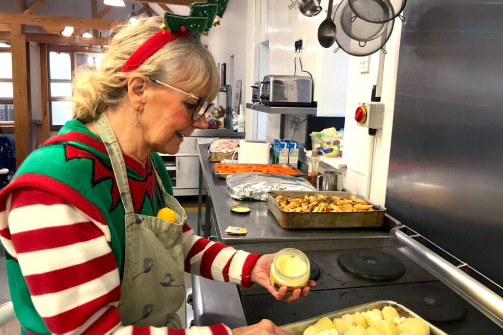 Woman in Christmas costume cooking
