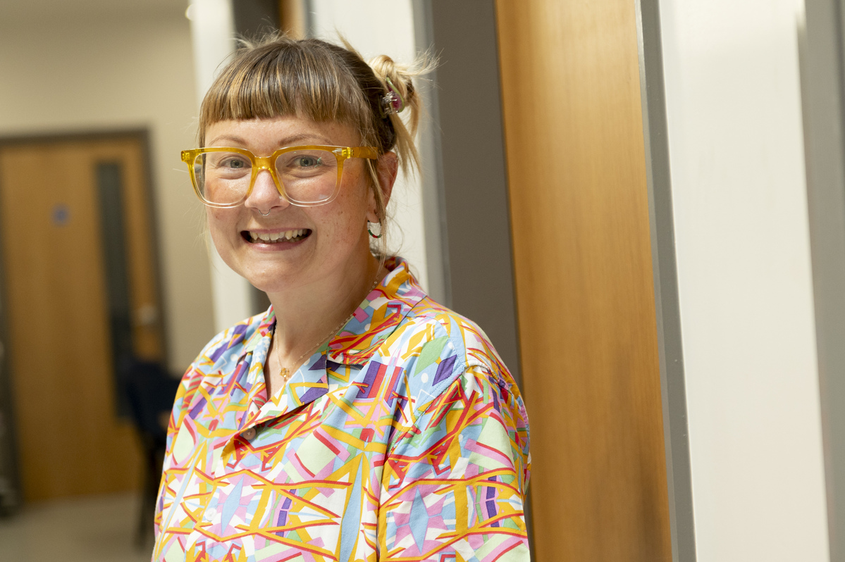 Woman in glasses smiling at camera